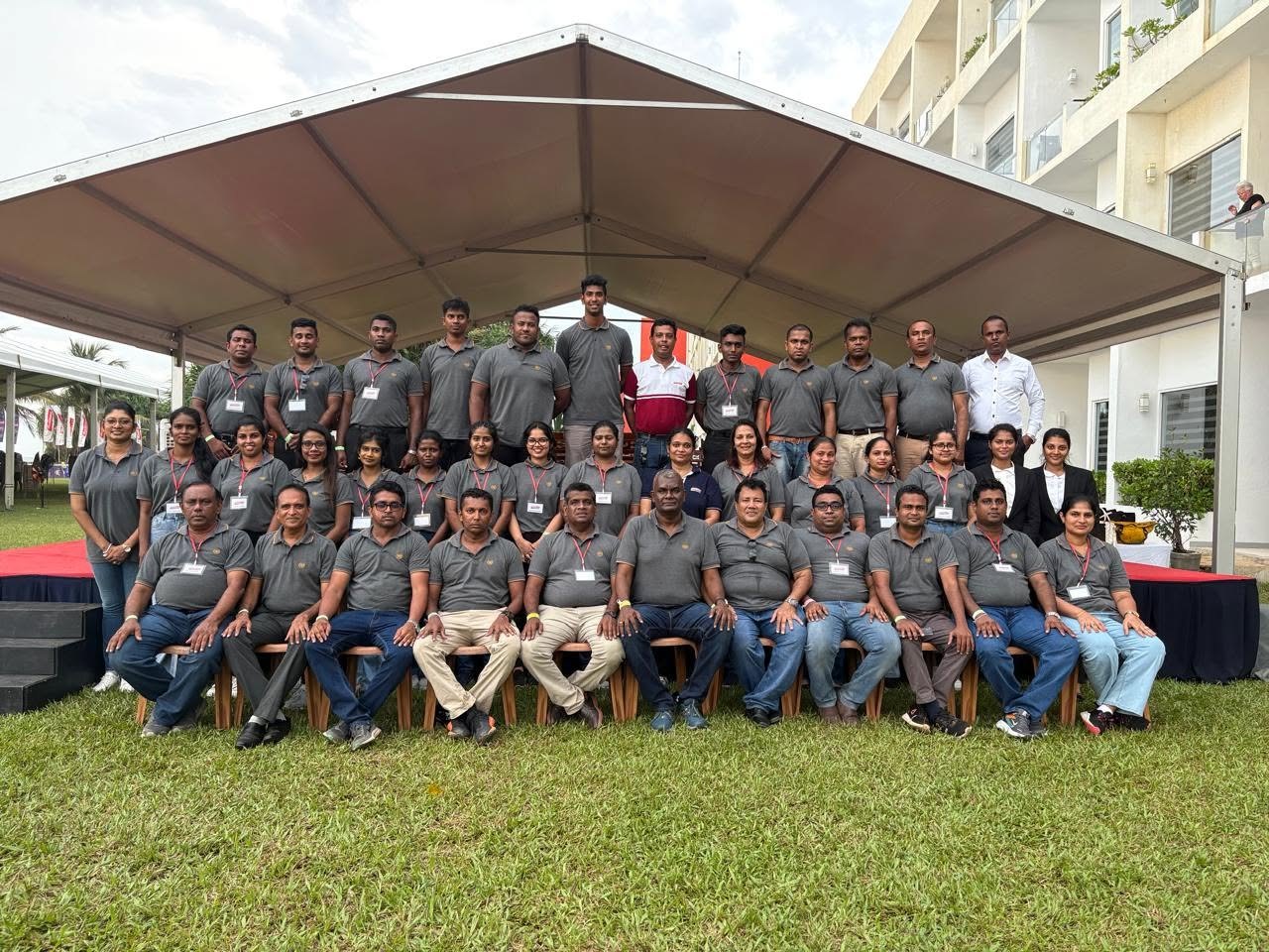 Corporate team in custom L & T polo shirts at an outdoor event
